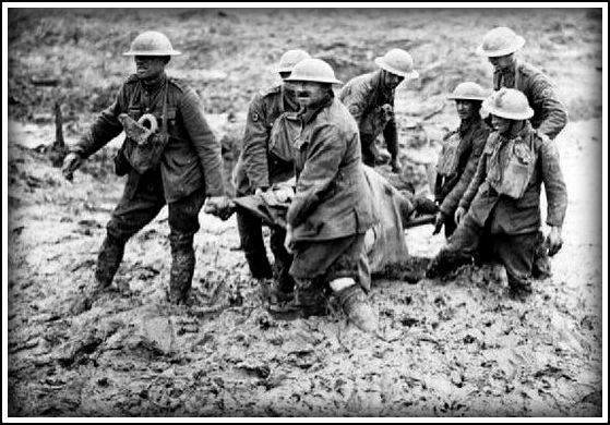 Stretcher bearers struggle in mud up to their knees